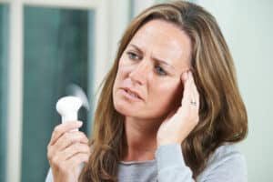 Woman Experiencing Hot Flush From Menopause